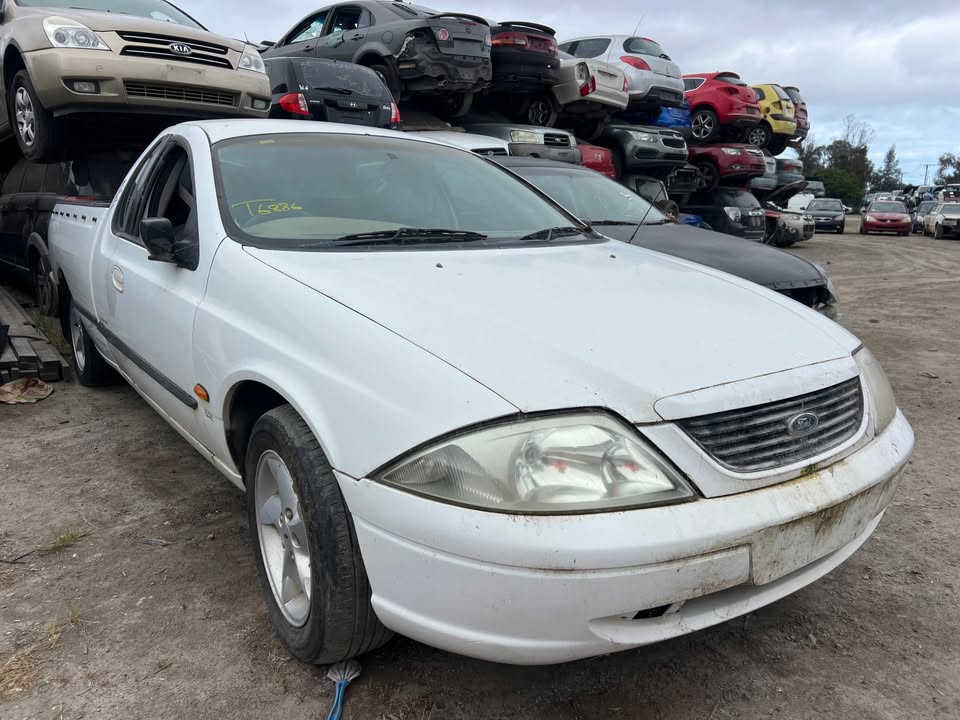 Wrecking scrap cars in yard